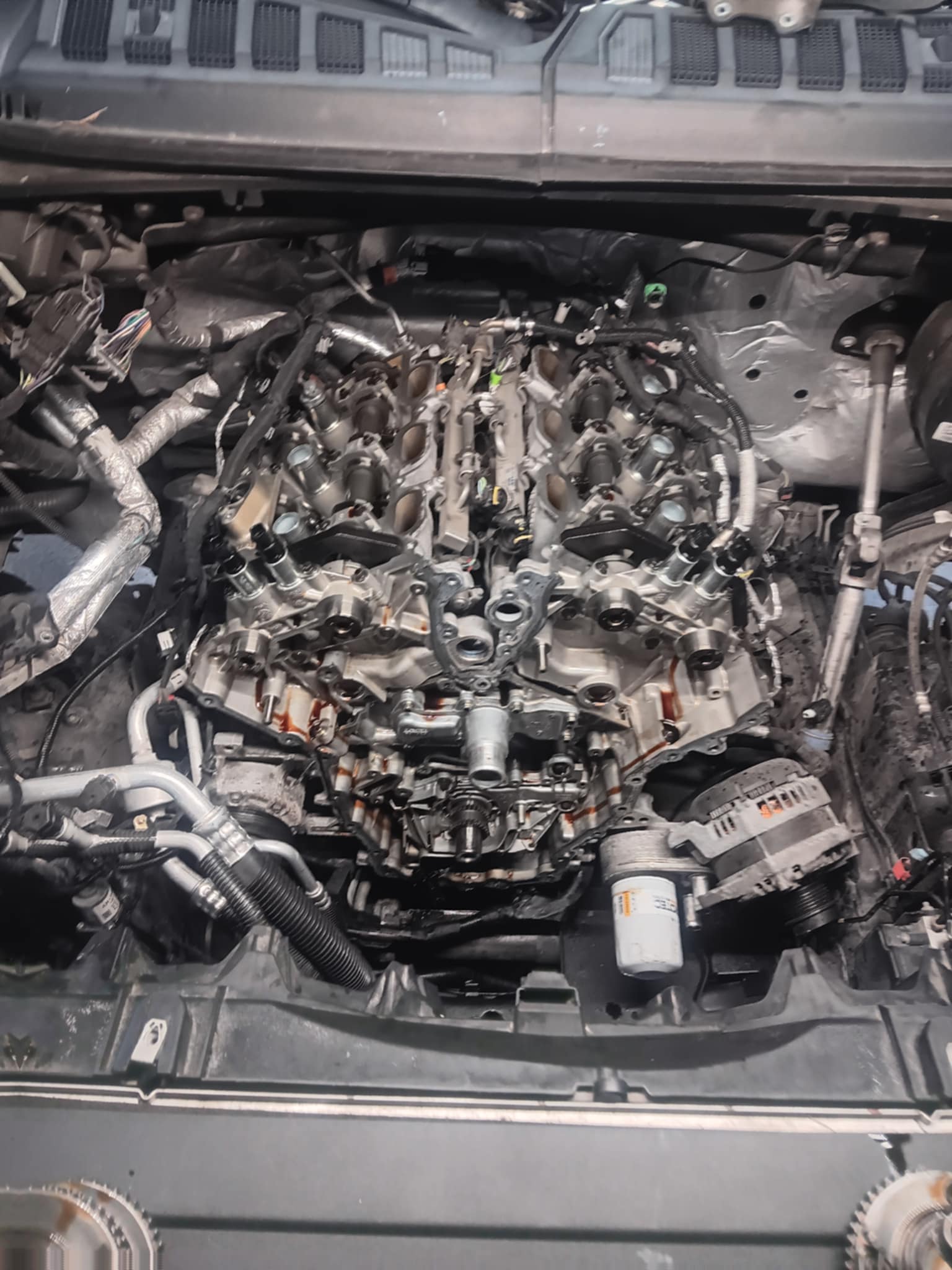 Engine bay stripped down for a repair, intake manifold removed