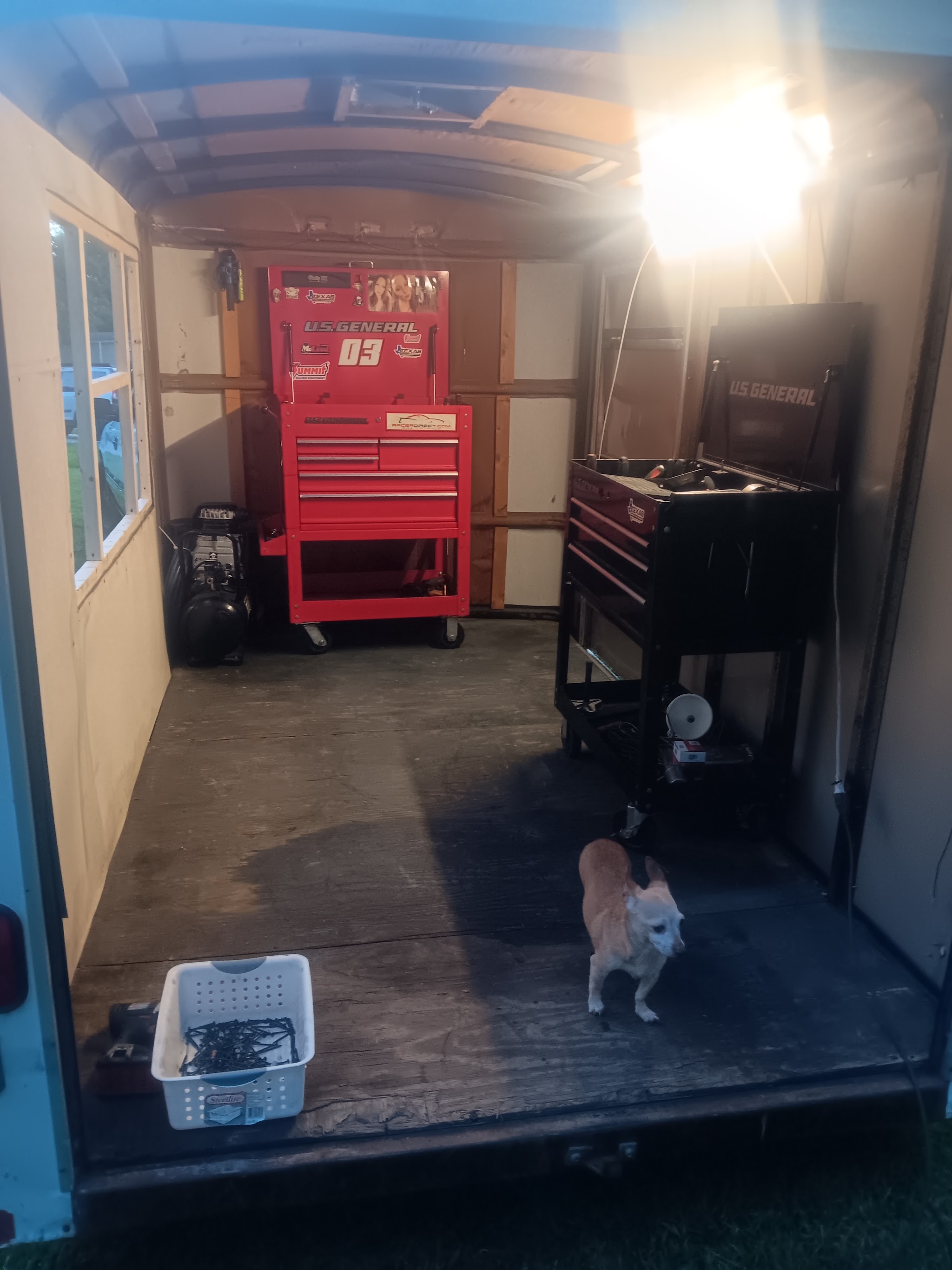 Inside the work trailer with two tool chests and an air compressor