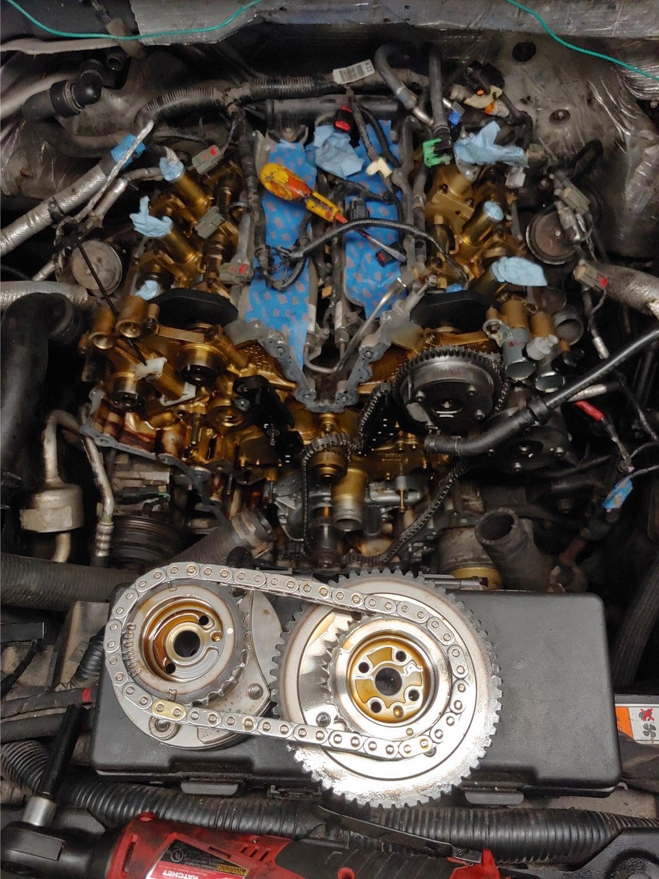 Close view of a timing chain and cam phasers during a job