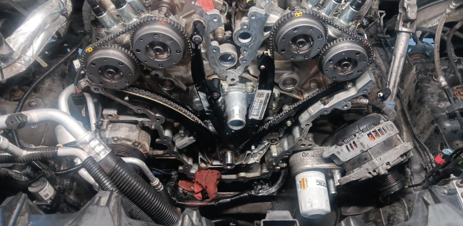 Engine with the timing chain assembly exposed in the middle of a repair